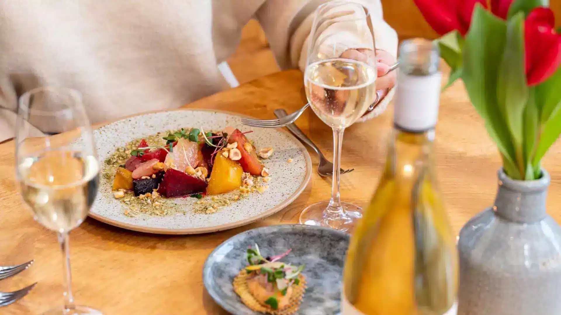 A set table with a plate of delicious food and a glass of Grand Pre Winery wine at Le Caveau in Grand Pre, Nova Scotia