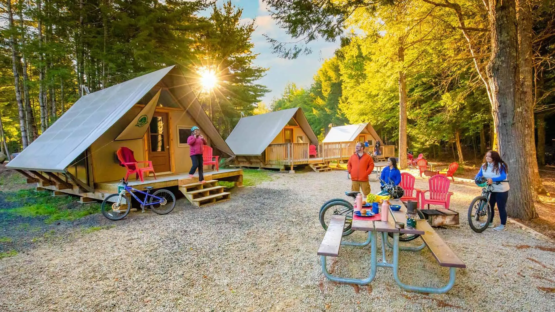 Family leaving their oTENTik accommodation to go biking in Kejimkujik National Park and National Historic Site.