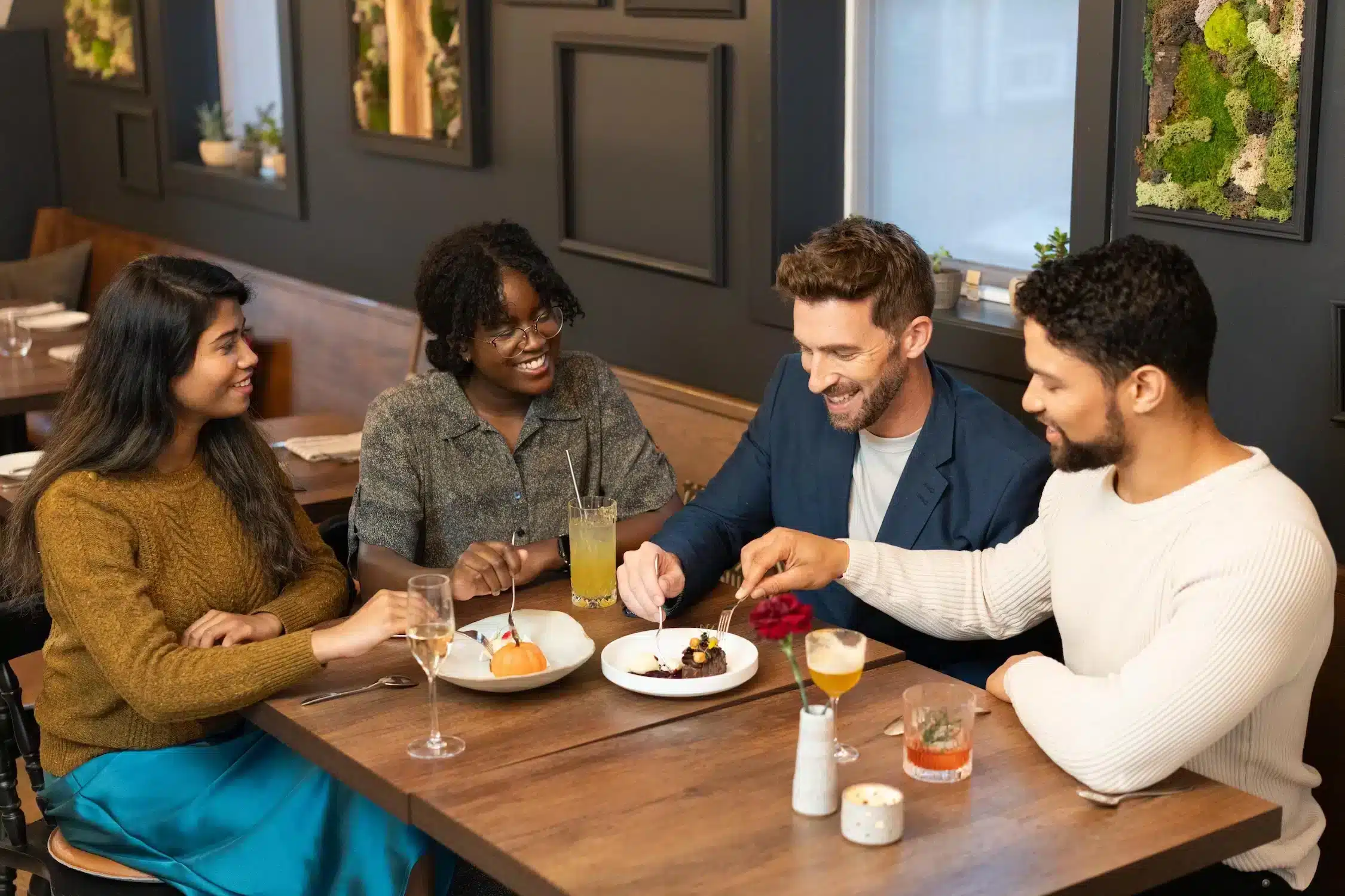 Four friends dining at Oxalis Restaurant in Downtown Dartmouth