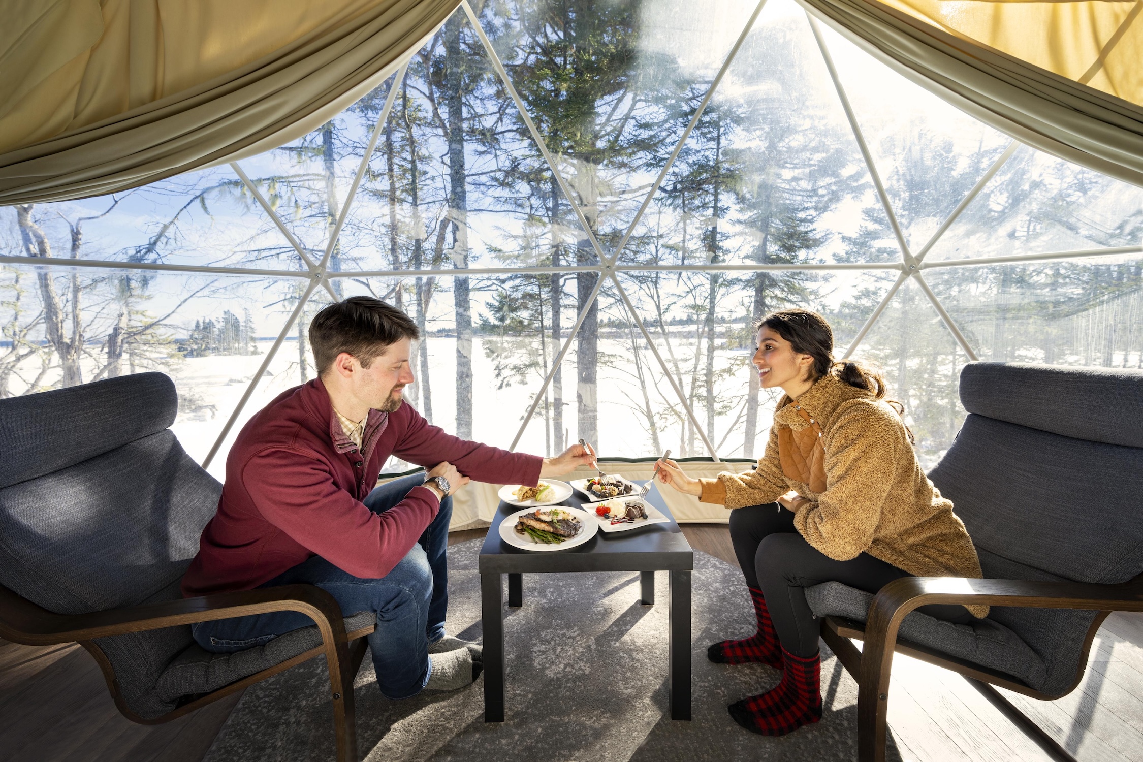 couple having dinner in a glamping dome